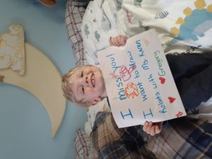 A child celebrates Teacher Appreciation Week at Coddington with a sign for their teacher 