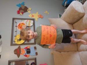 A child at the Coddington Road Community Center thanks this teacher with a sign for Teacher Appreciation Week 